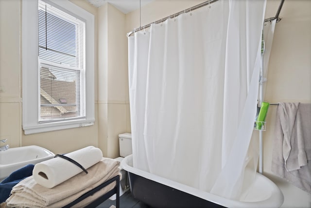 bathroom with a sink and shower / bath combo with shower curtain