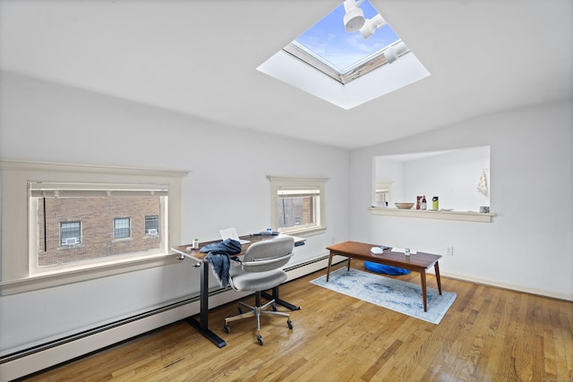 office with vaulted ceiling, wood finished floors, and a baseboard radiator