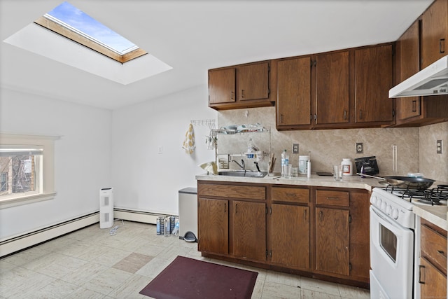 kitchen featuring a sink, light floors, white gas stove, and light countertops