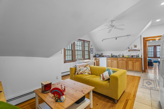 living area featuring recessed lighting, lofted ceiling, baseboard heating, and light wood-style flooring