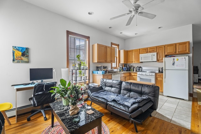 living room with recessed lighting, baseboard heating, light wood-style flooring, and a ceiling fan