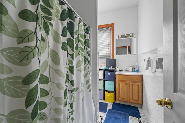 full bath with vanity, tile walls, a shower with curtain, and tile patterned flooring