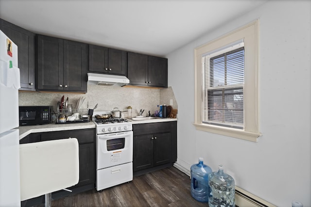 kitchen featuring backsplash, dark wood-type flooring, under cabinet range hood, light countertops, and white appliances