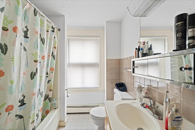 full bathroom featuring plenty of natural light, baseboard heating, tile walls, and toilet