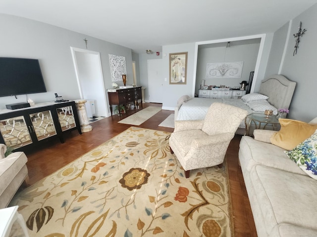 living area featuring baseboards and wood finished floors