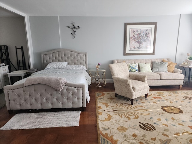 bedroom with baseboards and wood finished floors