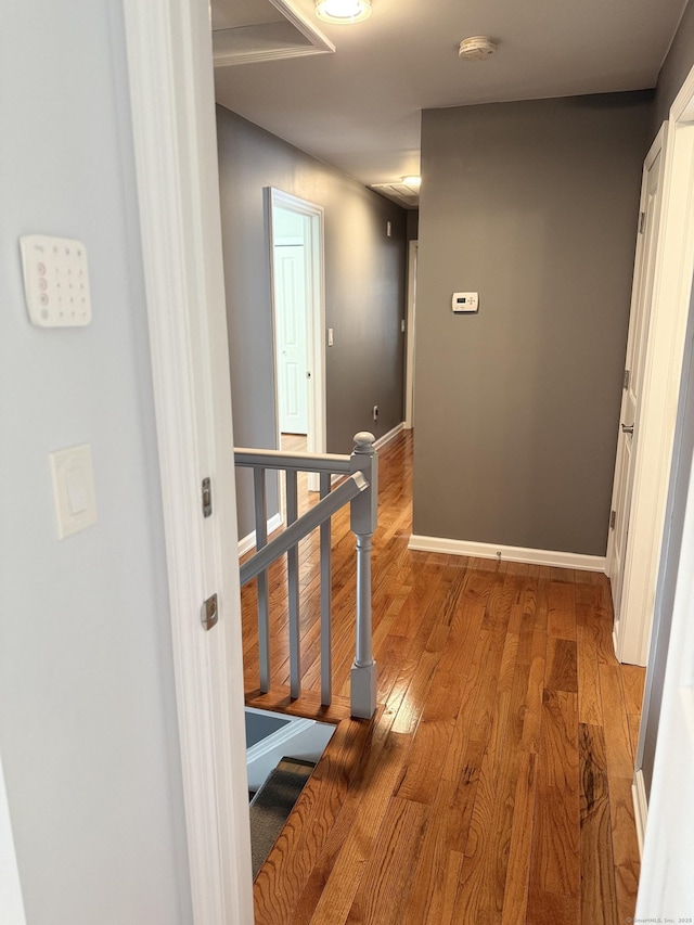 hall featuring baseboards and light wood-style floors