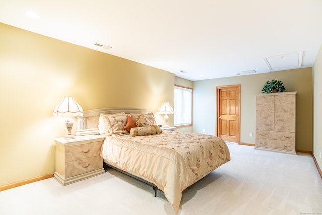 bedroom with attic access, visible vents, baseboards, and light carpet