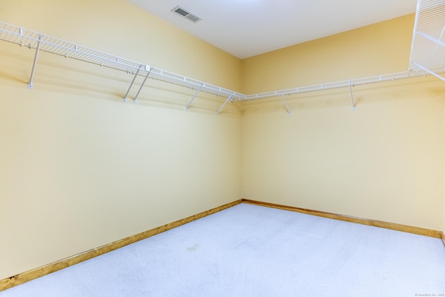 spacious closet featuring visible vents and carpet floors