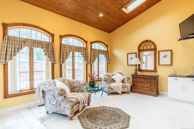 sitting room featuring a wealth of natural light, baseboards, wood ceiling, and vaulted ceiling