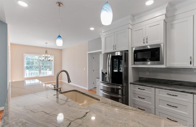 kitchen with white cabinets, stainless steel refrigerator with ice dispenser, built in microwave, and a sink