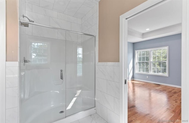 bathroom with tile walls and a shower stall