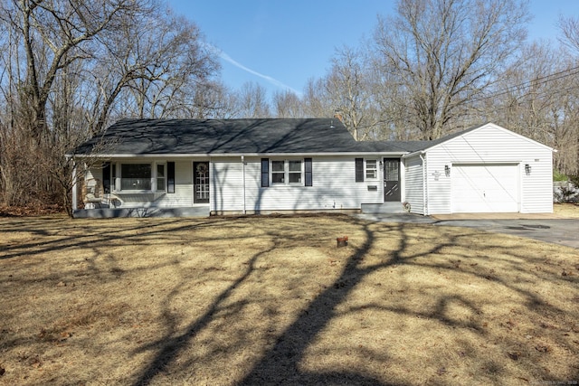 single story home featuring covered porch, an attached garage, driveway, and a front lawn