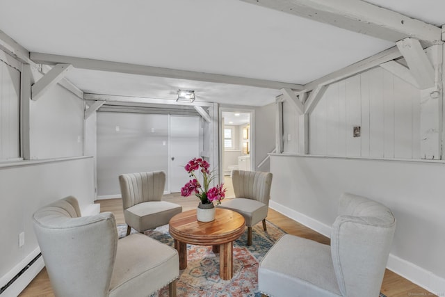 sitting room with light wood-style floors, baseboards, and baseboard heating