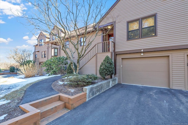 view of front of property featuring aphalt driveway and a garage