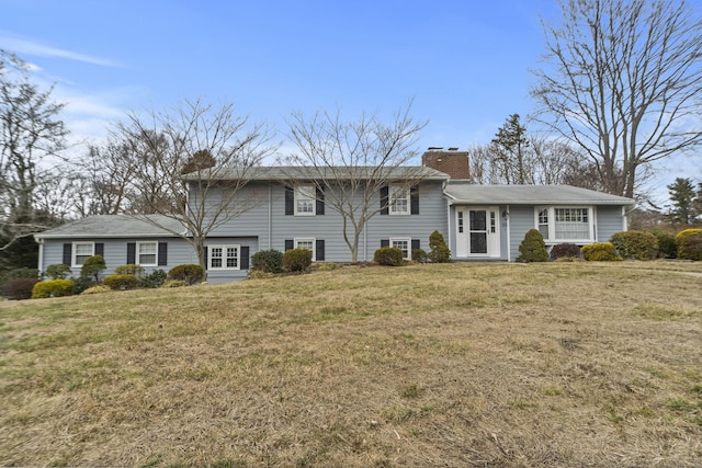 view of front of house with a chimney and a front yard