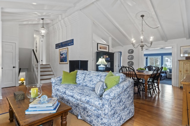 living room featuring vaulted ceiling with beams, wood finished floors, stairs, and an inviting chandelier