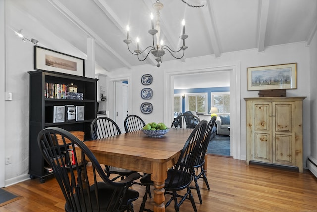 dining space featuring light wood-style flooring, vaulted ceiling with beams, baseboards, and a chandelier