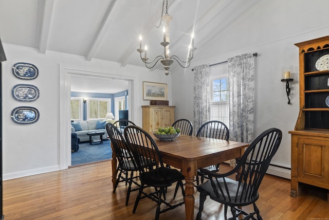 dining area featuring light wood-style flooring, a baseboard heating unit, baseboards, a chandelier, and vaulted ceiling with beams