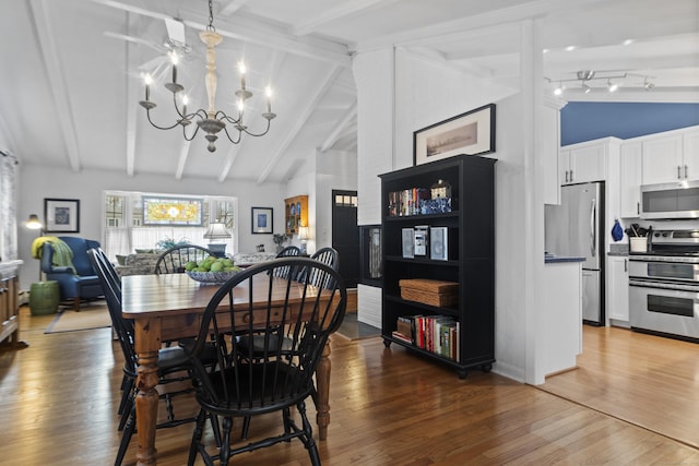 dining area featuring beam ceiling, high vaulted ceiling, an inviting chandelier, and wood finished floors