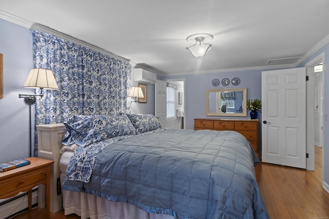 bedroom with a wall mounted air conditioner, visible vents, ornamental molding, dark wood-style floors, and a baseboard radiator