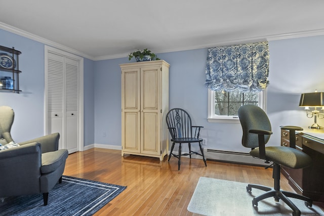 sitting room featuring baseboards, crown molding, and light wood-style floors