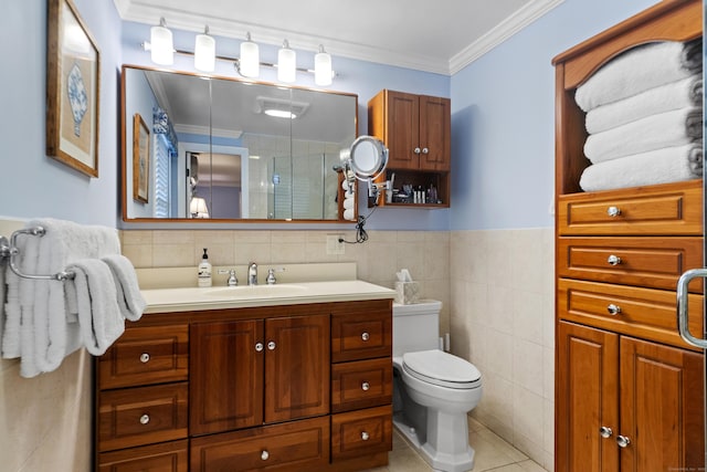 bathroom with a shower stall, tile walls, crown molding, tile patterned floors, and vanity