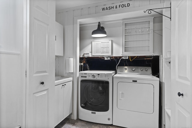 laundry room with washer and dryer and cabinet space