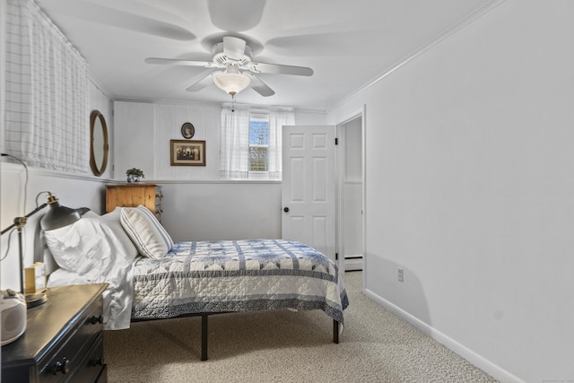 carpeted bedroom featuring ceiling fan, baseboards, and ornamental molding