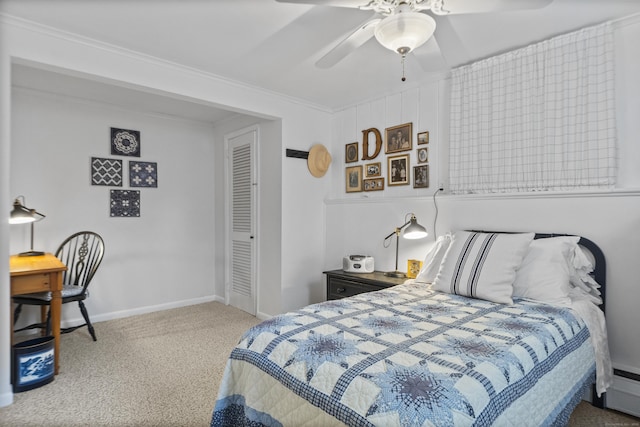 bedroom featuring ornamental molding, a baseboard heating unit, carpet floors, baseboards, and ceiling fan