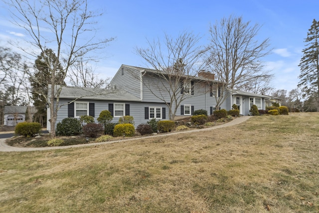 view of front of property featuring a front yard and a chimney