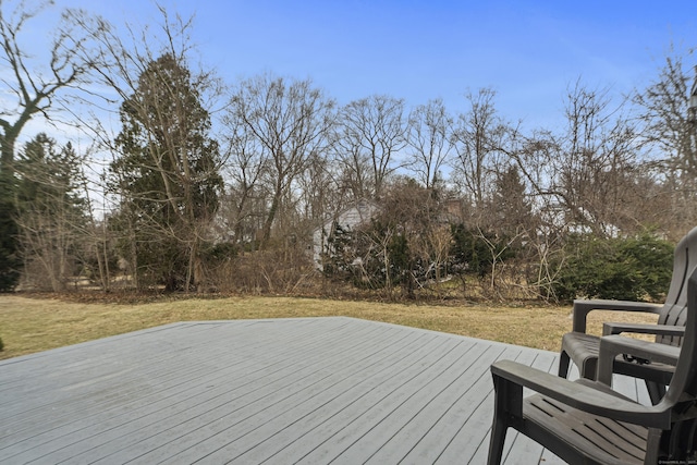 wooden deck featuring a lawn