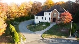 view of front of home with driveway and a front lawn