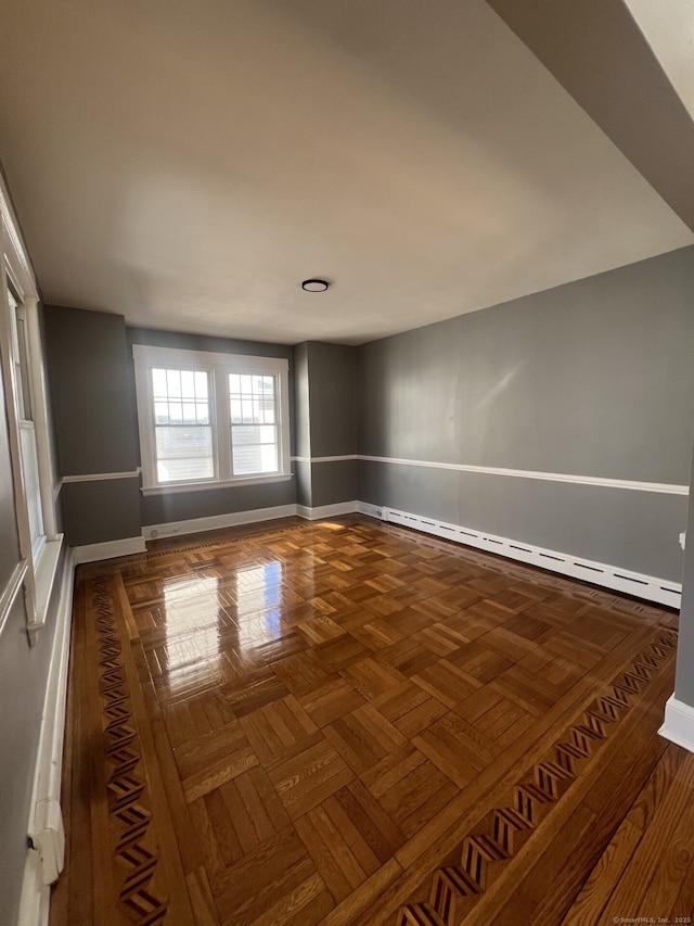 empty room with baseboards and a baseboard radiator