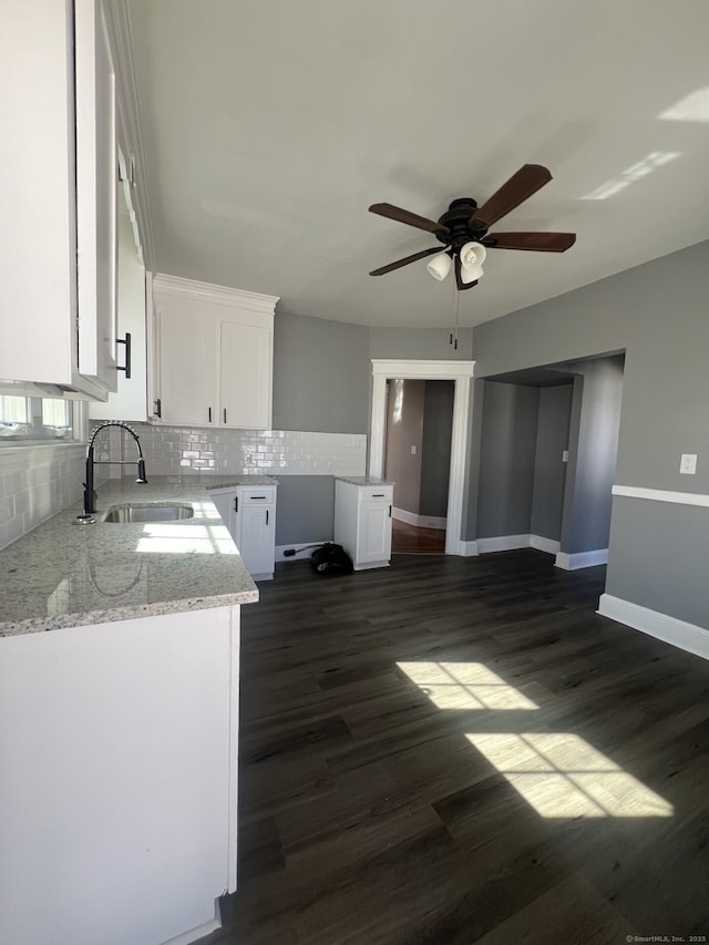 112 Concord St, Waterbury, CT 06710 - kitchen featuring tasteful backsplash, light stone countertops, a sink, white cabinetry, and a ceiling fan
