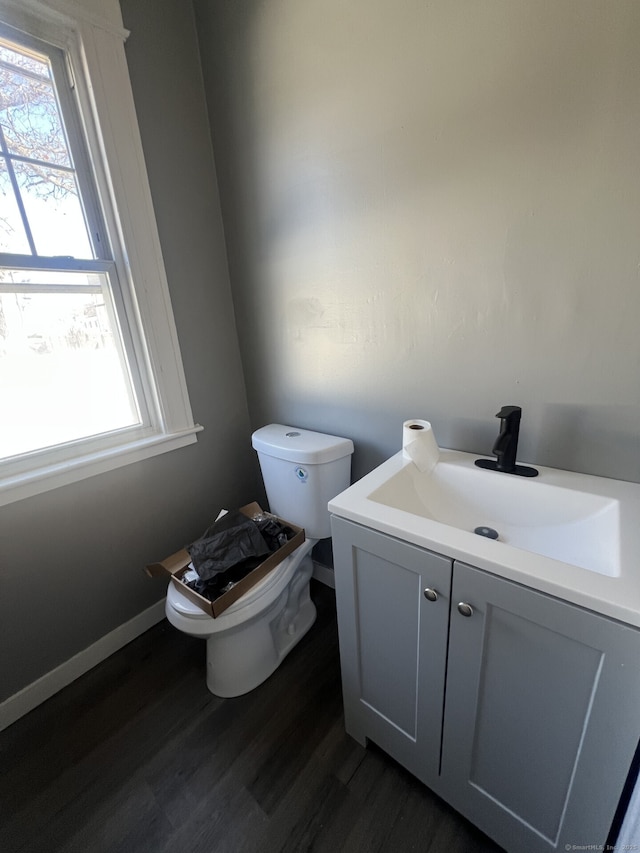 112 Concord St, Waterbury, CT 06710 - half bath featuring wood finished floors, a wealth of natural light, toilet, and vanity