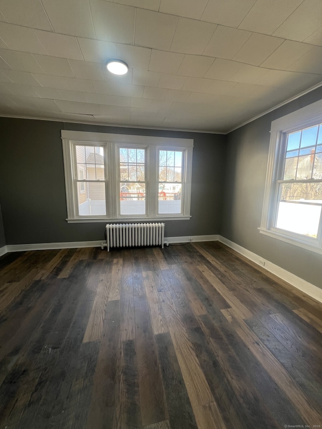 112 Concord St, Waterbury, CT 06710 - spare room with radiator, dark wood-style flooring, and baseboards
