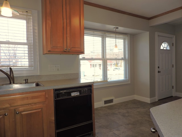 kitchen with visible vents, crown molding, light countertops, black dishwasher, and a sink