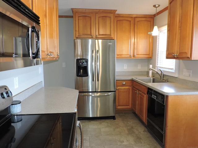 kitchen featuring a sink, light countertops, decorative light fixtures, and stainless steel appliances