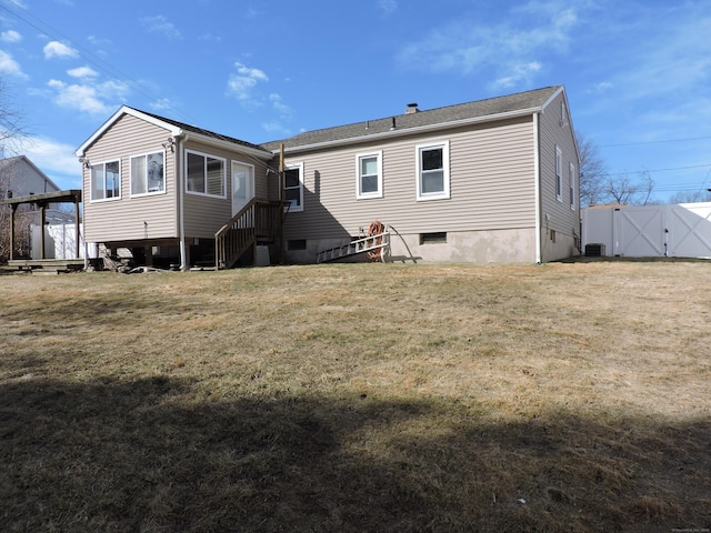 back of property featuring a yard and central AC