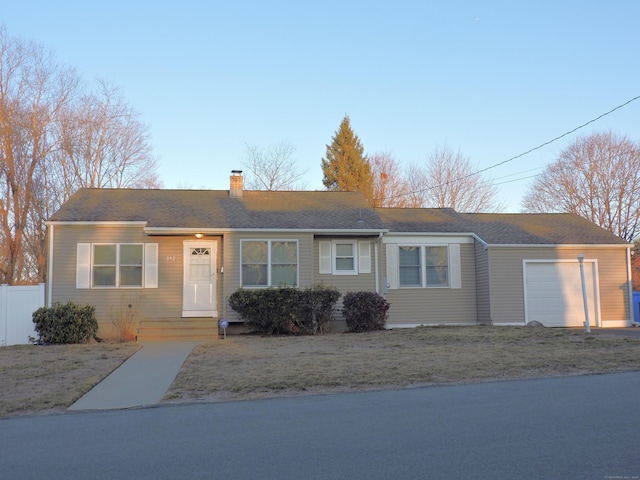 single story home with a chimney, a garage, and fence