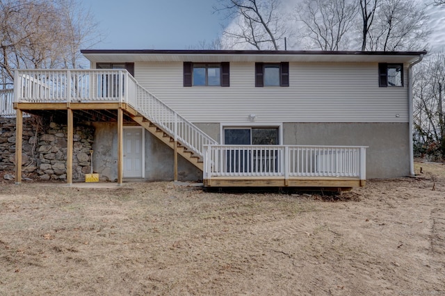 rear view of property with stairs and a wooden deck