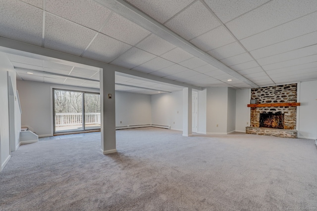 basement with a brick fireplace, carpet, and baseboards