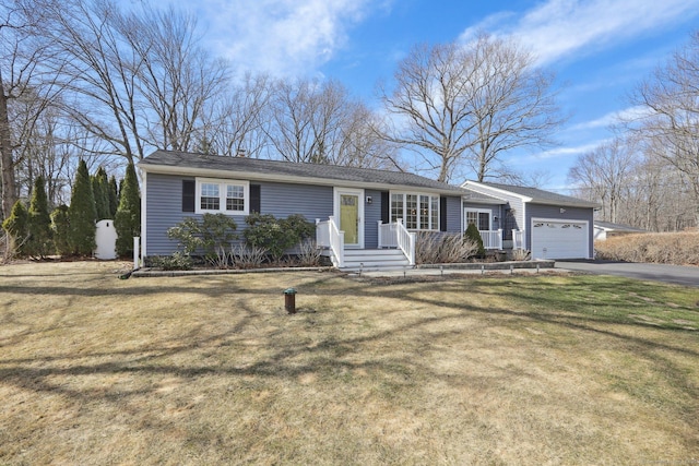 single story home featuring a front lawn, a garage, and driveway