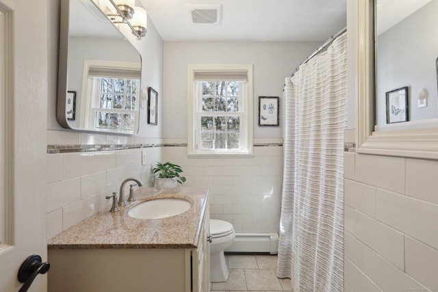 full bathroom featuring baseboard heating, toilet, tile walls, and visible vents