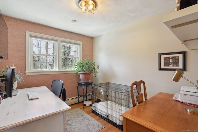 office area with baseboard heating and light wood-style flooring