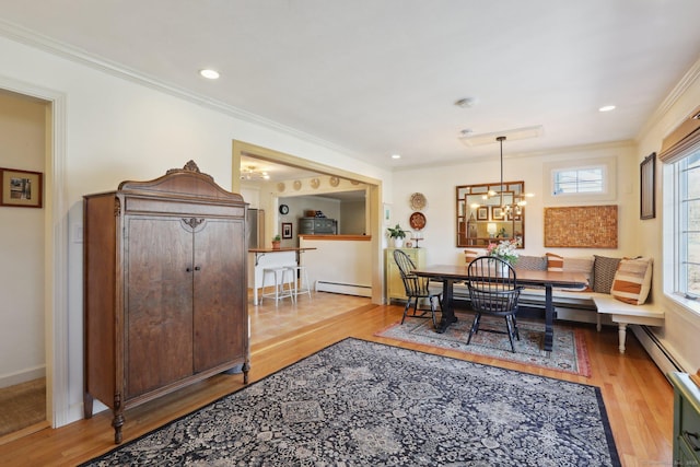 dining room featuring wood finished floors, an inviting chandelier, recessed lighting, ornamental molding, and baseboard heating