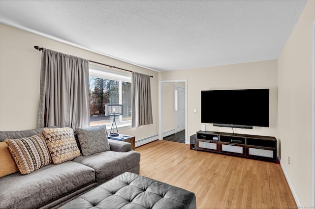 living room featuring a textured ceiling, wood finished floors, baseboards, and a baseboard radiator