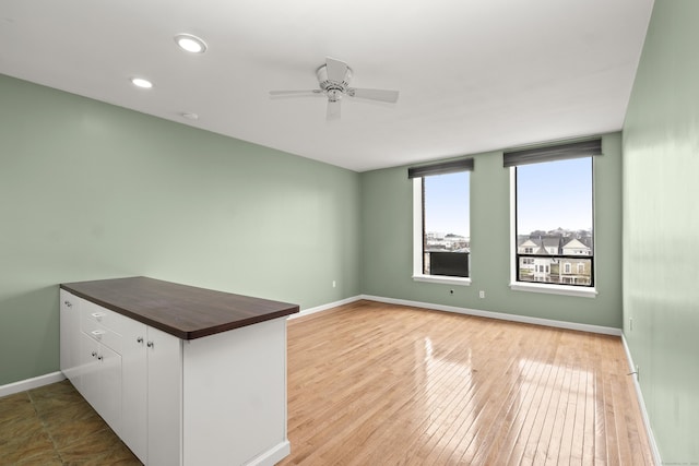 unfurnished room featuring ceiling fan, recessed lighting, baseboards, and light wood-type flooring