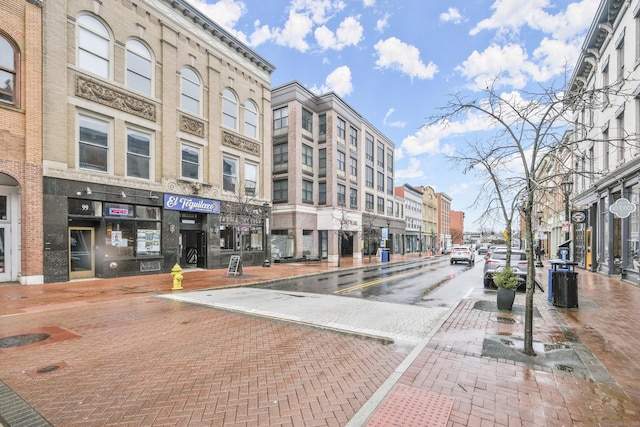 view of road featuring sidewalks, curbs, and street lights